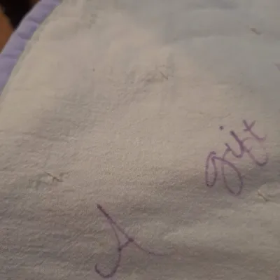 hand made lap quilt with writing on back side