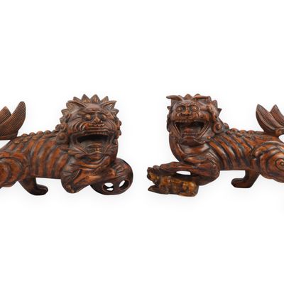 A Pair of Carved Vietnamese Hardwood Guardian Lion Figures