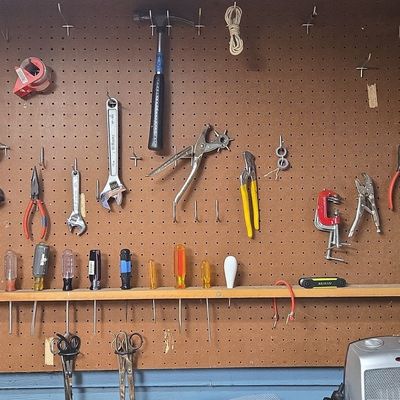 Assorted Hand Tool Collection on Pegboard