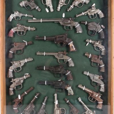 VINTAGE ICONIC CAST IRON CAP GUNS FRAMED - (26)