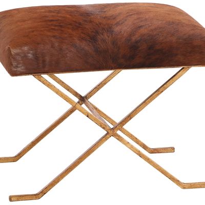 GILT IRON AND COW HIDE STOOL IN THE MANNER OF JEAN-MICHEL FRANK.