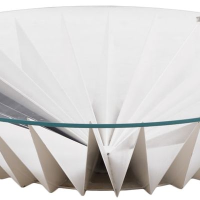 A FUTURISTIC DESIGNED ENAMELED IRON COFFEE TABLE WITH CIRCULAR GLASS TOP.