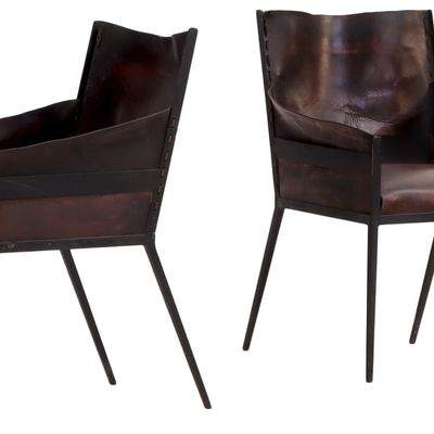 PAIR OF IRON AND LEATHER ARM CHAIRS IN THE MANNER OF JEAN-MICHEL FRANK.