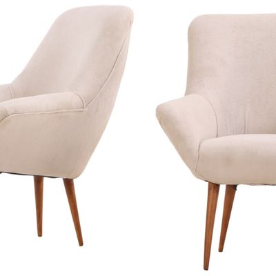 A PETITE PAIR OF UPHOLSTERED ARM CHAIRS C 1950 WITH NEW FABRIC.
