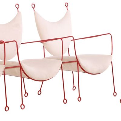 FOUR LARGE PAINTED IRON AND UPHOLSTERED ARM CHAIRS IN THE MANNER OF JEAN ROYERE.