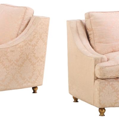 A PAIR OF SUBSTANTIAL UPHOLSTERED LOUNGE CHAIRS RESTING ON BRONZE FEET C 1960.