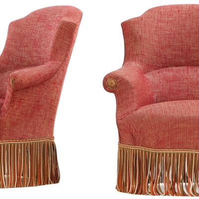 PAIR OF NAPOLEON III UPHOLSTERED LOUNGE CHAIRS RESTING ON EBONIZED TURNED FEET C 1870.