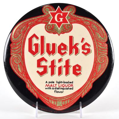 Sale Photo Thumbnail #547: Glueks Stite Malt Liquor 1950s Tin-Over-Cardboard Button Sign