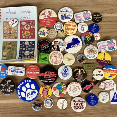 Sale Photo Thumbnail #403: An Assortment of Vintage Pinback Buttons, Keychains, and Political Button Reference Book