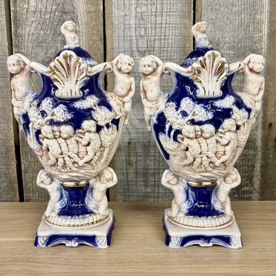 Sale Photo Thumbnail #13: A Pair of Norleans Italy Cobalt Blue and Gilt Ceramic Lidded Urns with Cherub Relief