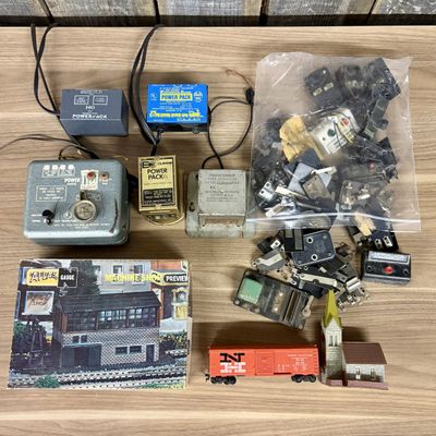 Sale Photo Thumbnail #606: An Assortment of Vintage HO and N Scale Model Train Transformers, Rolling Stock, and Track Accessories