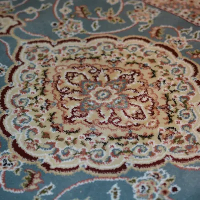 Soft Blue and Ivory Floral Rug – An ornate floral pattern with soft blue, cream, pink, and neutral tones.