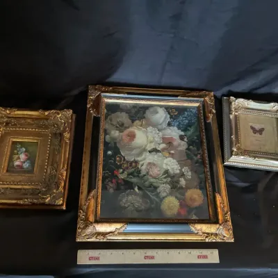 Three ornate pieces of wall art empty frame