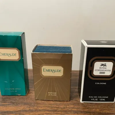 Three boxes of colognes and perfumes