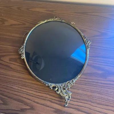 Ld ornate oval wall frame with intricate brass colored florals