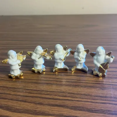 K set of five porcelain angel figurines playing musical instruments