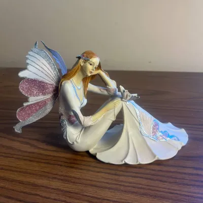 K delicate fairy figurine with glittered wings and flowing dress