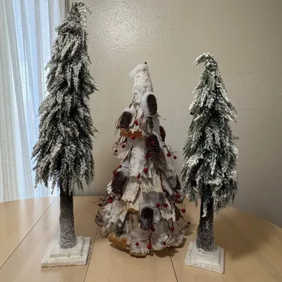 H assortment of 3 holiday decorative trees with snow and pine cones