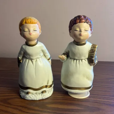 K puckering angel figurines with delicate gold accents and instruments