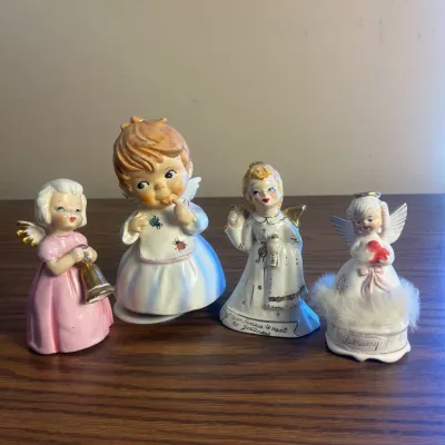 K set of four ceramic angel figurines with soft pastel colors