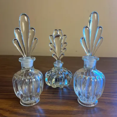 p Set of Three Vintage Clear Glass Perfume Bottles with Ornate Stoppers H- 8in and 7in .jpg