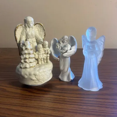 k Collection of Three Decorative Angel Figurines Featuring Porcelain and Frosted Glass.jpg