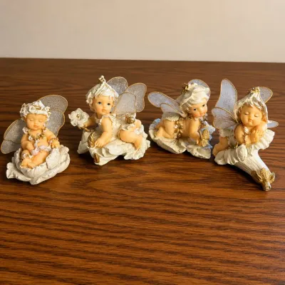 K set of four delicate baby fairy figurines with glittered wings