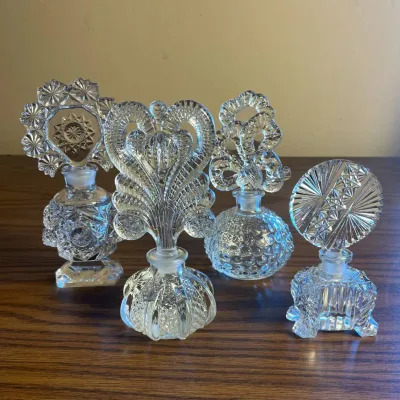 p Set of Four Vintage Cut Glass Perfume Bottles with Intricate Stoppers H- 7in, 6.5in, 6in, and 5in.jpg