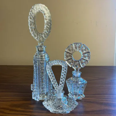 p Cut Glass Perfume Bottles with Intricate Stoppers and Distinct Sizes H- 11.5in, 7in, and 5.5in .jpg
