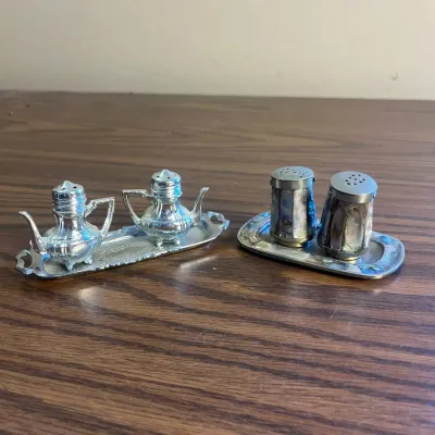 K miniature silver colored salt and pepper shakers with trays