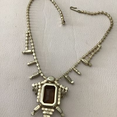 Beautiful vintage, mid-century, large emerald, cut smoky topaz or amber colored center rhinestone accented with yellow and topaz colored...