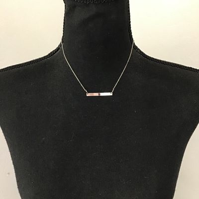 Minimalist silver bar necklace, featuring a small Denzel set red garnet or ruby gemstone on a delicate chain