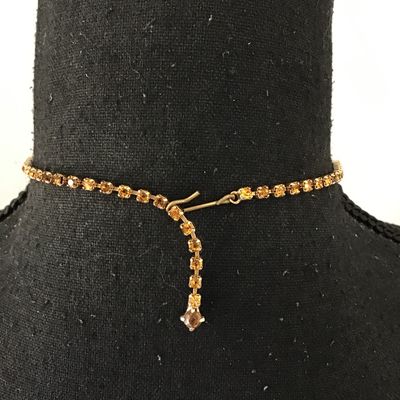 Beautiful vintage, mid-century, large emerald, cut smoky topaz or amber colored center rhinestone accented with yellow and topaz colored...