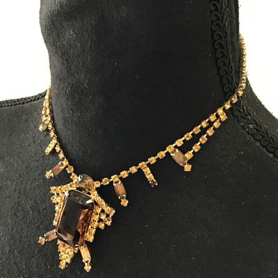 Beautiful vintage, mid-century, large emerald, cut smoky topaz or amber colored center rhinestone accented with yellow and topaz colored...