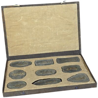 A Set of Nine Chinese Gilt and Polychrome Molded Inksticks