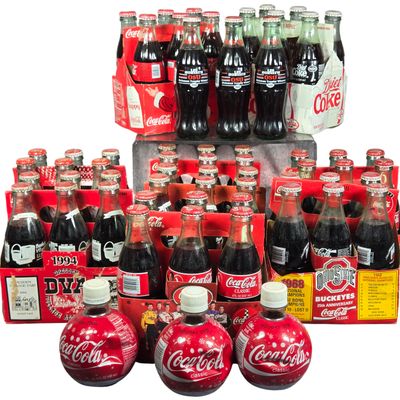 A Collection of Commemorative and Vintage Coca-Cola and Diet Coke Beverage Bottles and Carriers