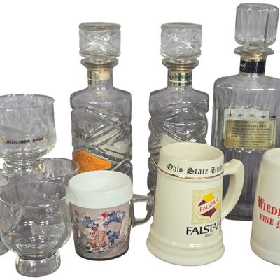 A Collection of Vintage Advertising Whiskey Decanters, Beer Steins, and Promotional Glassware