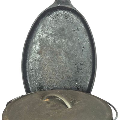 Two Lodge Cast Iron Cookware Pieces Including Dutch Oven and Large Oval Griddle