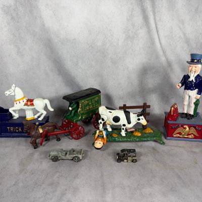 A Collection of Cast Iron Mechanical Bank Reproductions and Die-Cast Vehicles