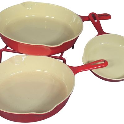 A Trio of Griswold 100th Anniversary Enameled Cast Iron Skillets with Rack
