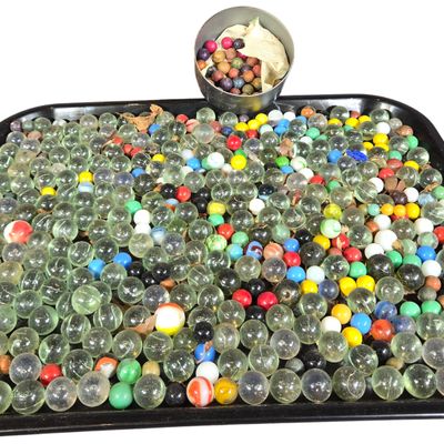 An Assortment of Vintage Marbles with a Stenciled Apple Crate and Storage Container
