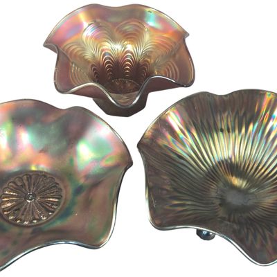A Trio of Fenton Amethyst Carnival Glass Bowls in Orange Tree, Dahlia, and Thin Rib Patterns
