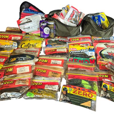 An Assortment of Bass Fishing Soft Plastic Lures, Stren Fishing Line, and Tackle Pouches