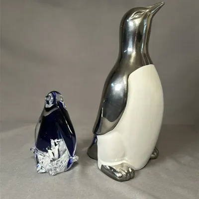 One (1) Silver-Tone Ceramic Penguin &  One (1) Blue Art Glass Penguin Figurine