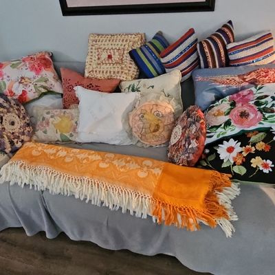 Assorted Decorative Throw Pillows and Fringe Throw Blanket