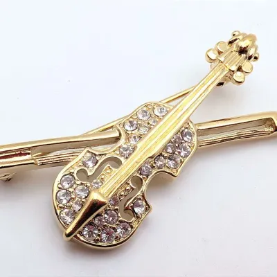 Sale Photo Thumbnail #89: Vintage Trifari Gold Tone and Rhinestone Violin Brooch