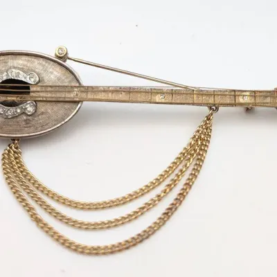 Sale Photo Thumbnail #87: Robert Mandle Gold Tone and Rhinestone Signed Mandolin Brooch