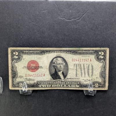Sale Photo Thumbnail #160: 1928-D Series $2 Red Seal Note. No Writing and 4 good corners. In protective sleeve.
