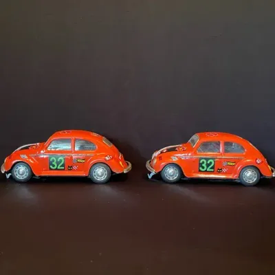 Two 1960s VW Bug Battery Operated Stamped Metal Toy Race Cars