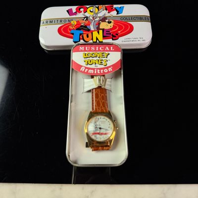 Sale Photo Thumbnail #200: Armitron Looney Tunes Merrie Melodies Musical Quartz Gold-Tone Watch with Original Tin 32mm